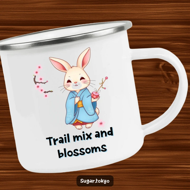 Funny graceful rabbit in a blue kimono offering cherry blossom candies on a metal camping mug, designed for elegant and funny adventures.