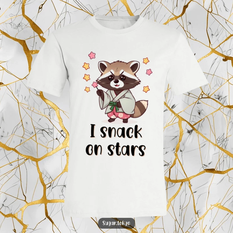 Funny t-shirt featuring a mischievous raccoon in a cool kimono, expertly catching colorful falling candy stars.